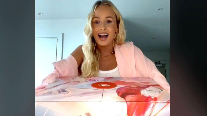 Cissy Jones holding a pink and red box in one of her beauty advent calendar TikTok videos