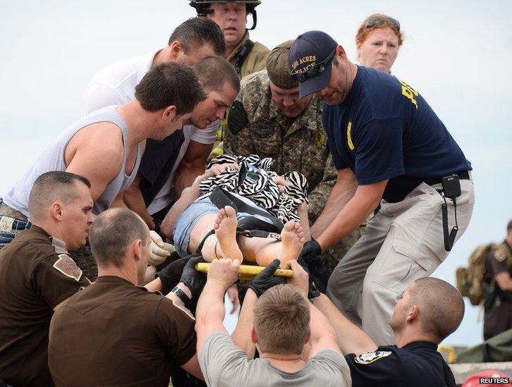 Rescue workers carry a woman to safety from the Moore Medical Center