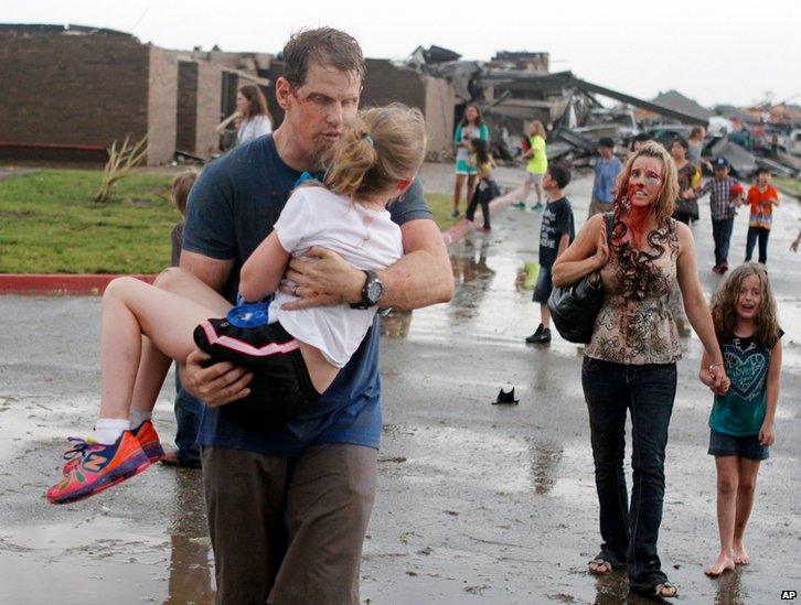 Teachers carry children away from Briarwood Elementary school in south Oklahoma City