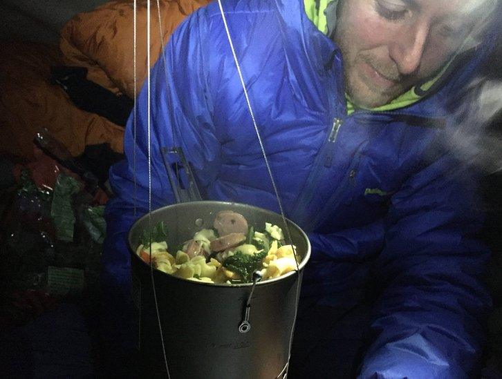 Tommy Caldwell preparing a meal during his climb