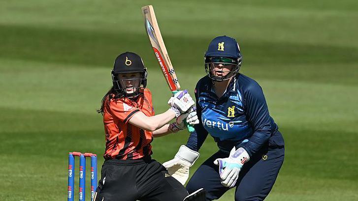 Sarah Bryce looks on with the wicketkeeper behind her after hitting the ball for The Blaze