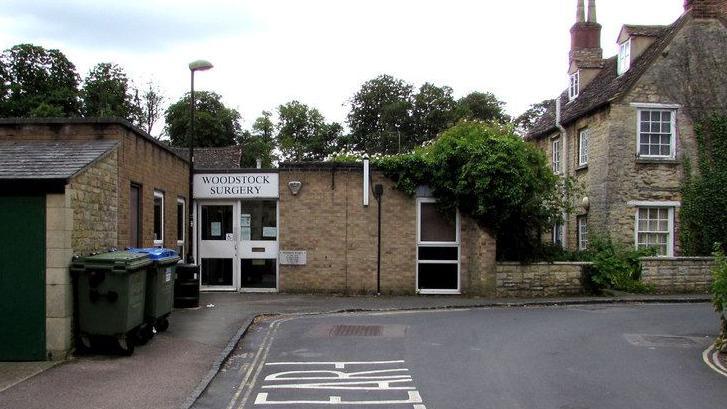 The exterior of Woodstock Surgery, a single-storey building with a flat roof. 