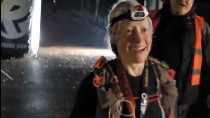 Anna after crossing the finish line. She has a head torch on her head
