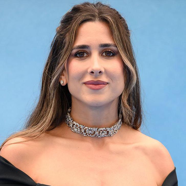 Mercedes Ron in evening dress and a diamond choker - she is young with long, mid-brown hair 