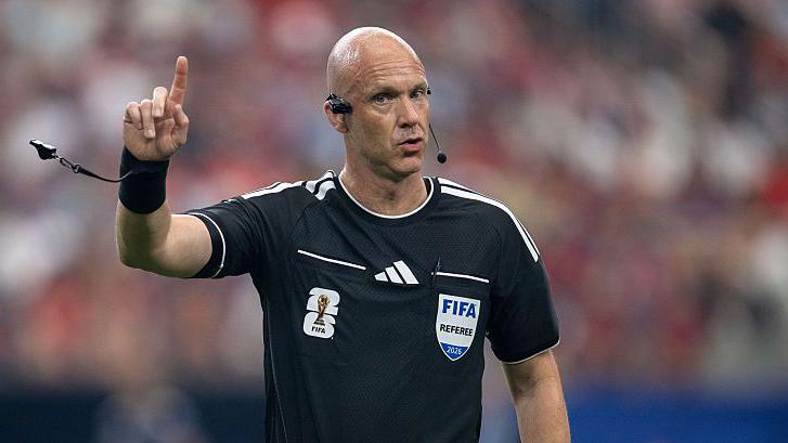 Anthony Taylor gesticulates while refereeing a match