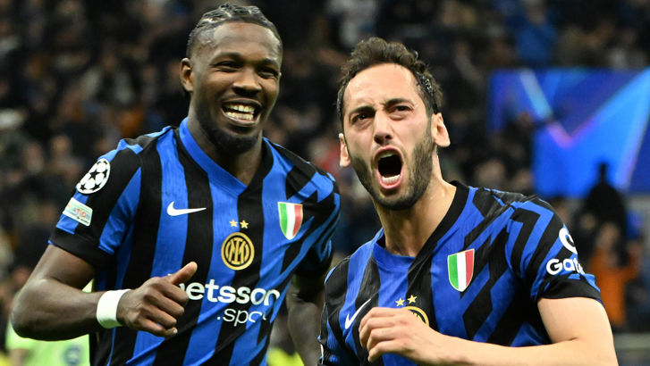 Inter Milan's Hakan Calhanoglu (right) celebrates scoring against Barcelona in the Champions League