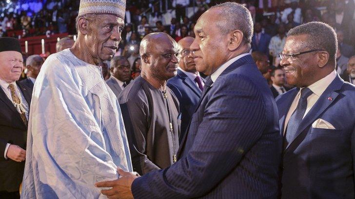 Issa Hayatou (with hat) shakes hands with Ahmad