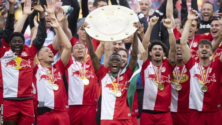 Zambia striker Patson Daka lifts the Austrian Bundesliga trophy in front of his RB Salzburg team-mates