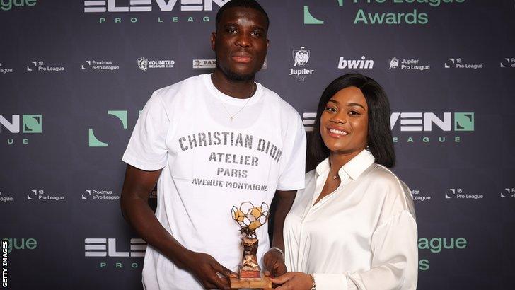 Nigeria and KRC Genk striker Paul Onuachu and his partner Tracy Acheampong with the Belgian Professional Footballer of the Year award