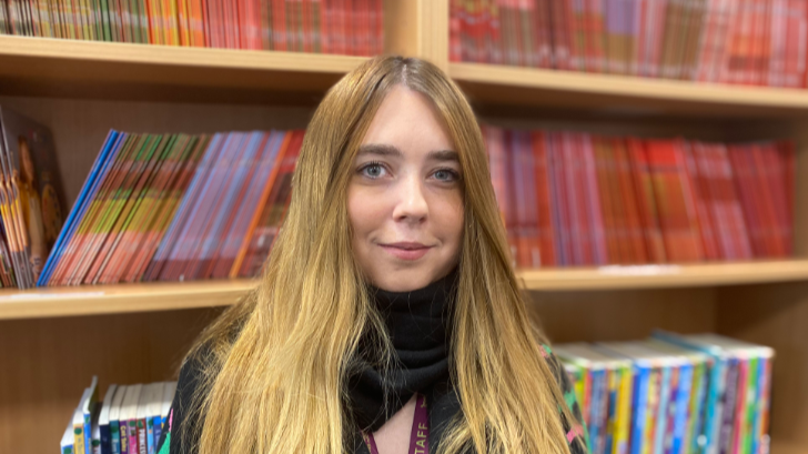 Woman in front of bookcase