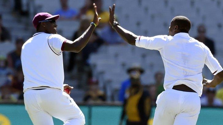 Jason Holder and Carlos Brathwaite celebrate an Australian wicket