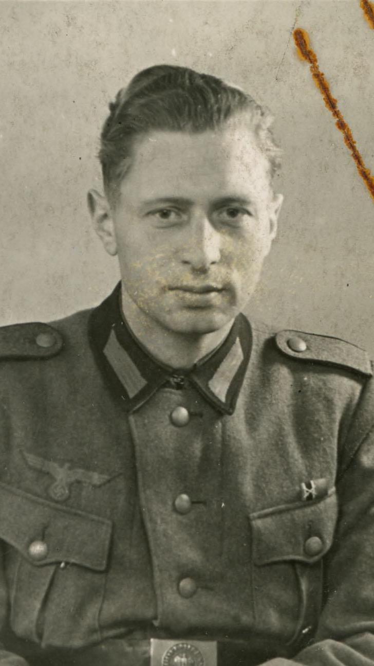 A black and white photo of a World War Two German soldier in uniform.