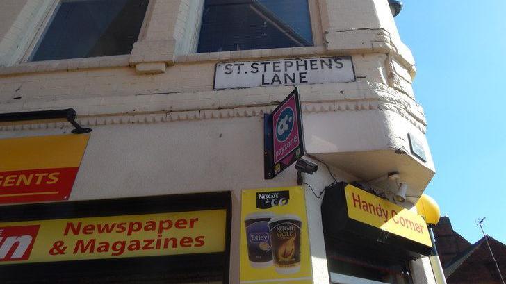 The road sign for St Stephen's Lane in Ipswich, which is above a corner shop.