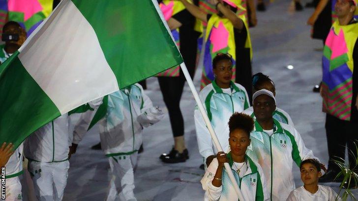 Nigerian table tennis player Funke Oshonaike carrying the Nigerian flag at the Rio Olympics opening ceremony