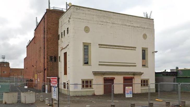 Former brick-built cinema with a faded art deco frontage in disrepair before demolition