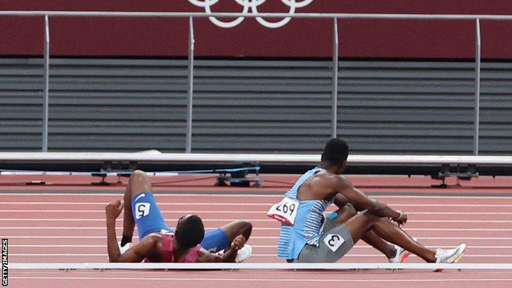 Botswana's Nijel Amos (right) and USA's Isaiah Jewett sit on the track after falling during the semi-finals of the men's Olympic 800m