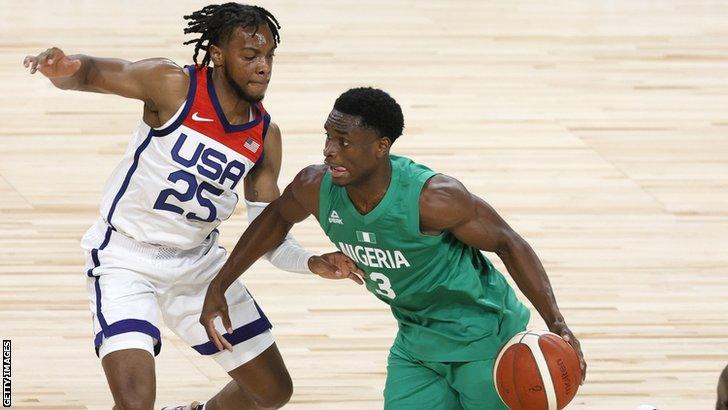 Nigeria basketballer Caleb Agada (right) takes on the USA's Darius Garland