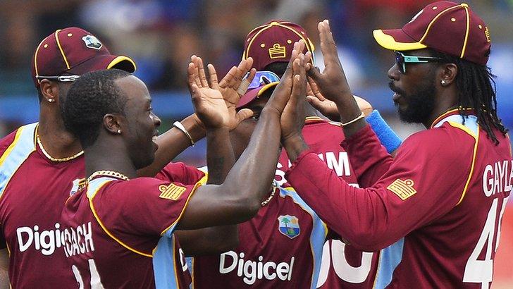 West Indies players celebrate taking the wicket of Indian batsman Shikhar Dhawan