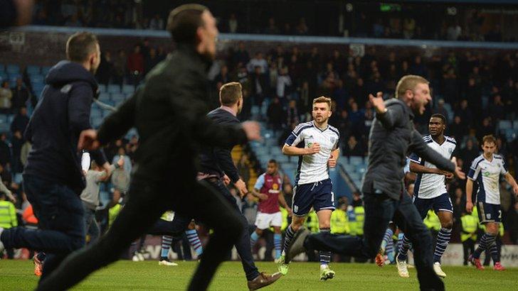 Fans invade the pitch during the FA Cup quarter-final with West Brom