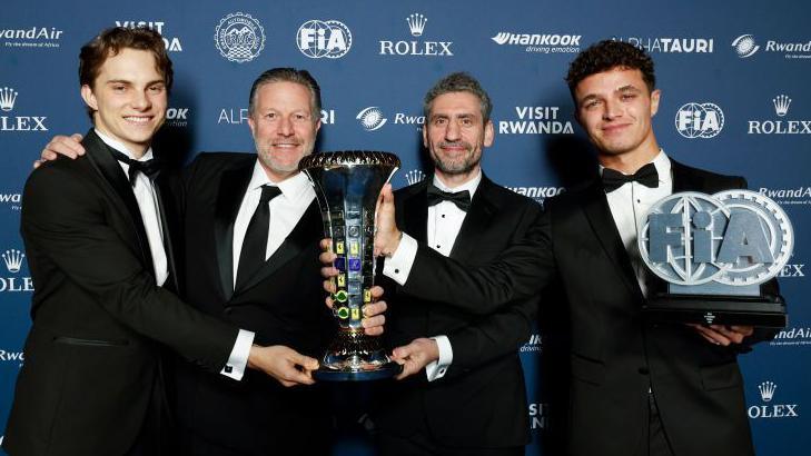 Oscar Piastri, Zak Brown, Andrea Stella, and Lando Norris from McLaren pose for a photograph with the Constructors Championship award in 2024