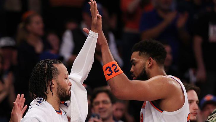 New York Knicks' Jalen Brunson high-fives team-mate Karl-Anthony Towns