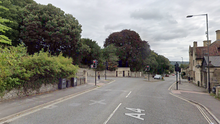 A Google Maps street view of a road junction in Bath. An image of a red traffic light and cars turning in.