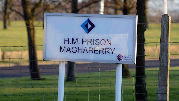 A white sign which says "H.M. Prison Maghaberry"