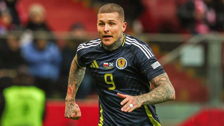 Lyndon Dykes in action for Scotland against Poland