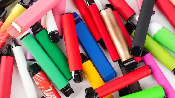 Brightly coloured vapes in a pile