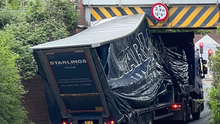 Lorry stuck under a bridge