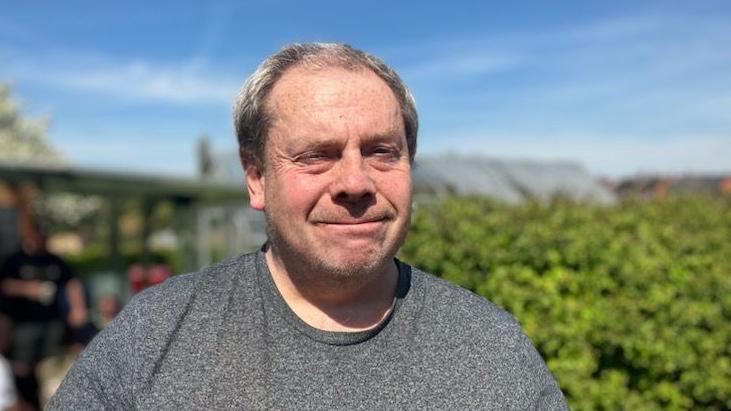 Friary user Gary Douglas at the allotment wearing a grey shirt
