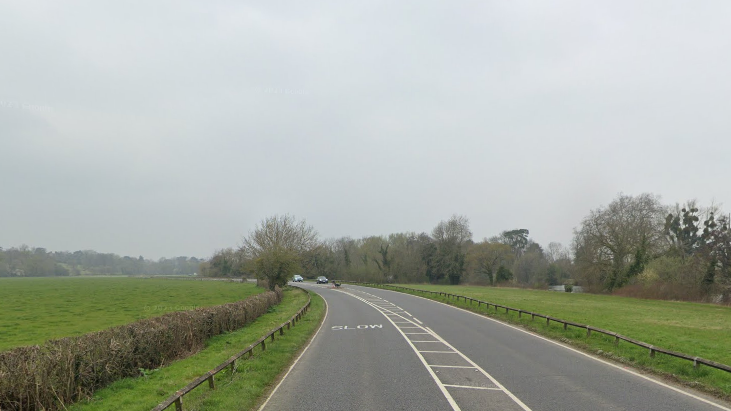 A Google Maps picture of Windsor Road, a road with fields and trees on either side of a road with one lane on either side.