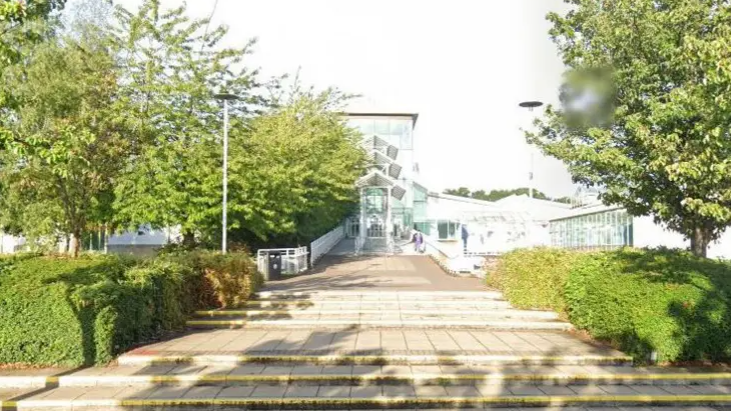 Steps lead up to the entrance of glass fronted building - Spectrum Leisure Centre