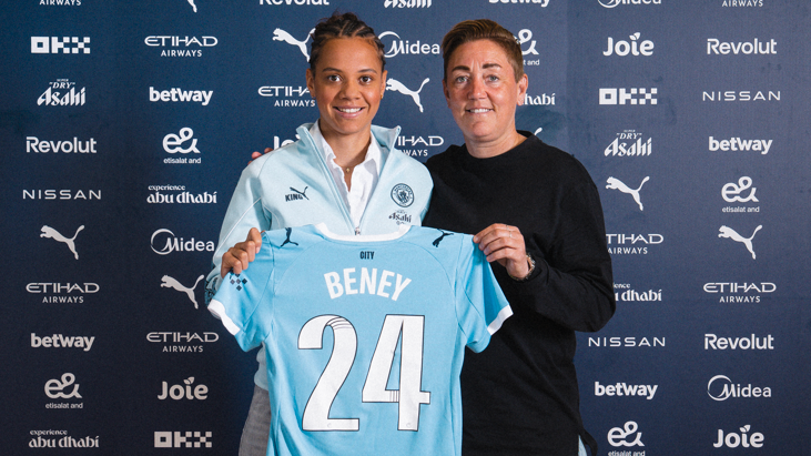 Iman Beney poses with a Manchester City shirt which has her name on