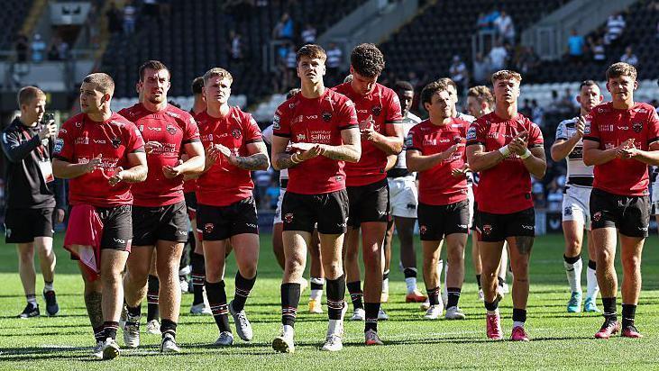 Salford Red Devils' young squad applauds after their heavy defeat by Hull FC earlier in August