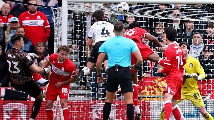 Adam Randell (number four) powers home a header for Bristol City