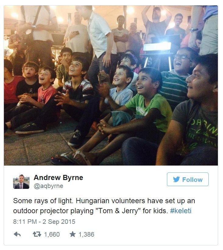 Tweet: Some rays of light. Hungarian volunteers have set up an outdoor projector playing "Tom & Jerry" for kids.