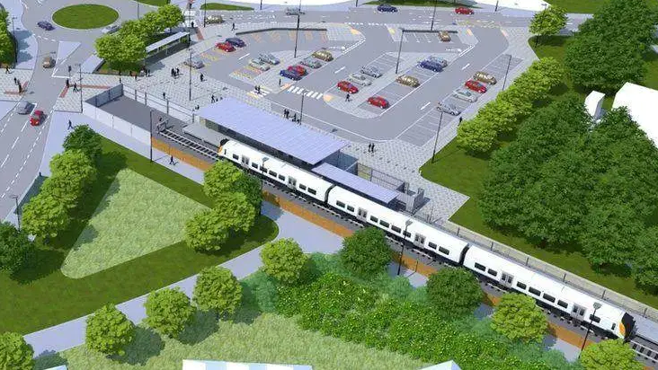 An artist's impression of the new line, showing a car park and railway line with a road and trees around it