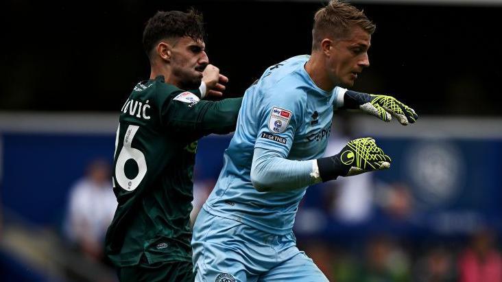 Paul Nardi of Queens Park Rangers in action against Mihailo Ivanovic of Millwall