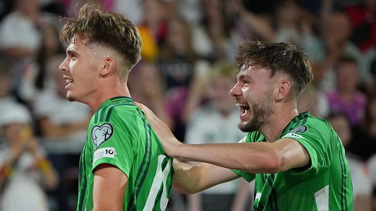 Isaac Price and Conor Bradley celebrate