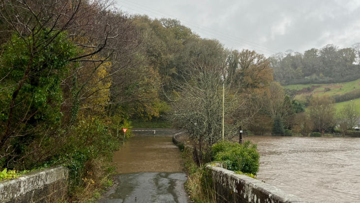 Road flooded next to flooded fields in Devon