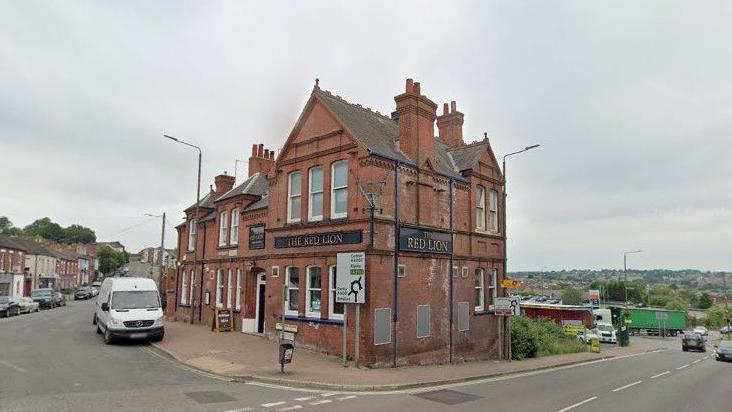 A Google street view image showing The Red Lion pub in Heanor at the junction of the A608 and Derby Road.