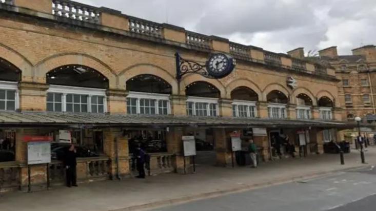 York station - a light stone building with information stands outside 