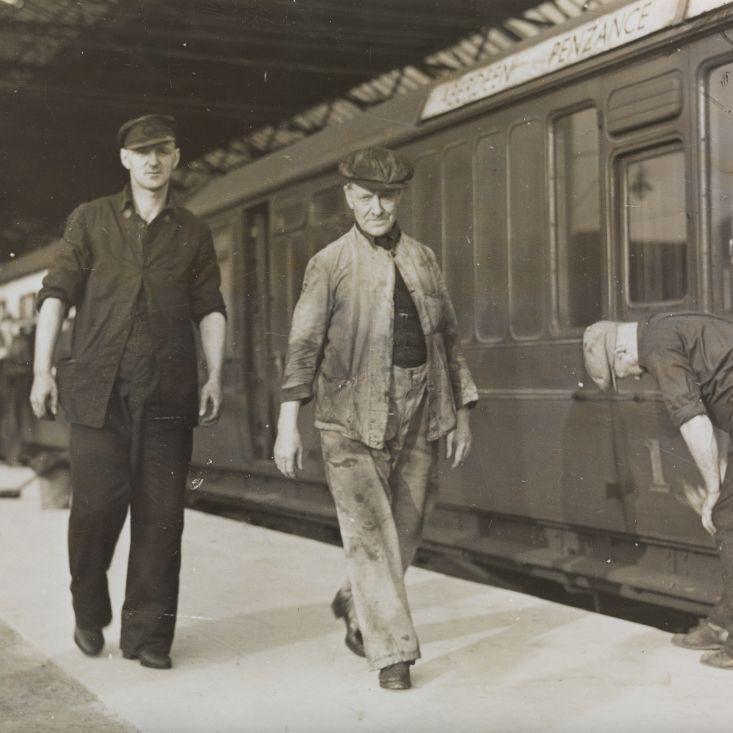 Black and white image of train workers next to the Aberdeen to Penzance train in 1939.