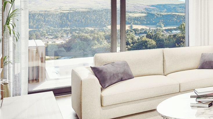 A CGI of the interior of the townhouse, a white sofa with views over Ramsey.