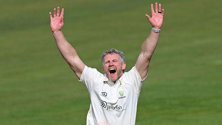 Glamorgan bowler Timm van der Gugten throws his arms up in the air as he appeals for a decision
