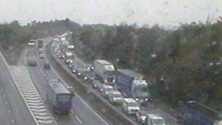 The eastbound direction (to the right of the traffic camera image) is full of cars and lorries stuck in traffic. The image is slightly blurry as the camera has been covered in raindrops from the bad weather.