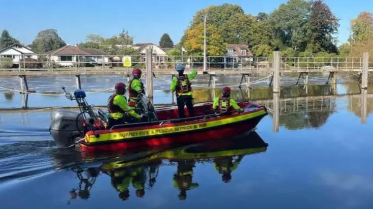 An inflatable emergency boat with several people on board on the river