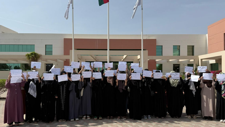 A group of Afghan women holding placards 