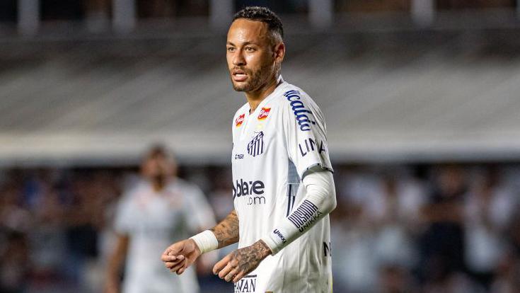 Neymar stands on a pitch